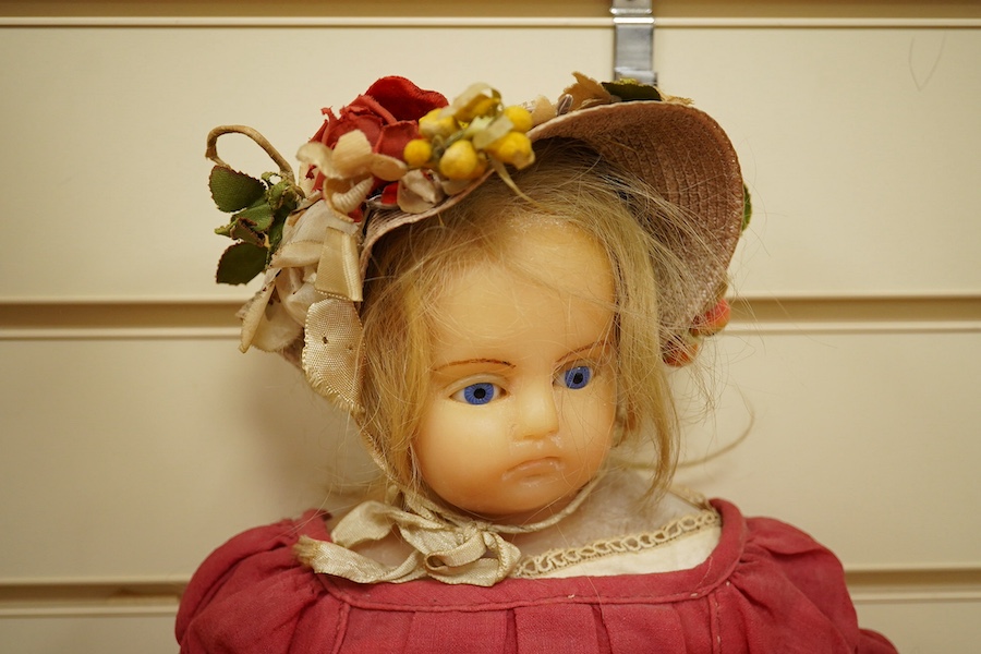 A 19th century poured wax shoulder doll, paperweight eyes and jointed limbs, 60cm. Condition - some damage